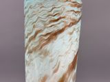 a vase that has a brown and white design on it