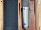 a microphone in a wooden box on a table