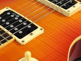 an orange and yellow electric guitar sitting on top of a table