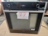 a microwave with a price tag on it sitting on a cardboard box