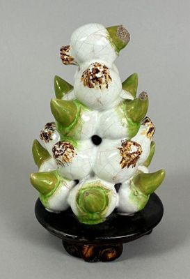 porcelain figurine of a white bird with green leaves on a black base
