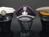 three hats on a mannequin head on a black background