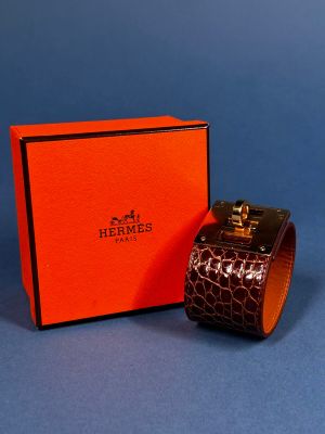 an orange box with a watch inside of it on a blue surface