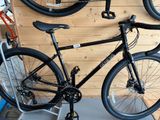 a bike hanging on the wall in a bike shop