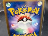 a plastic box with a pokemon card inside of it