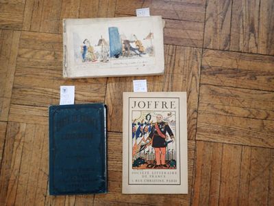 three books sitting on a wooden floor next to each other