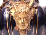 a large vase with a face on it on a white surface
