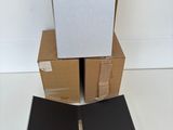 three boxes stacked on top of each other on a white surface