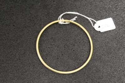 a close up of a gold ring with a tag on it