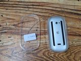 a plastic case with a sticker on it next to an apple mouse