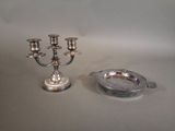 a silver plate with a candelab and a silver ashtray