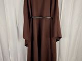the back of a brown coat with a belt on a mannequin dummy