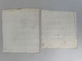 two pieces of old paper are sitting next to each other