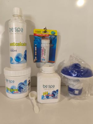 bottles of soap, toothbrushes, toothpaste, and toothpaste sitting on a counter