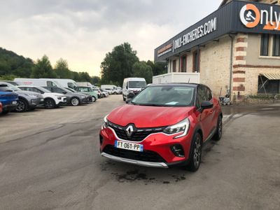a red car parked in front of a building in a parking lot