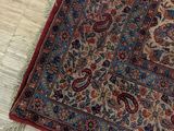 a rug on the floor with a cat sleeping on it