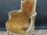 an old fashioned chair with a gold velvet upholstered seat