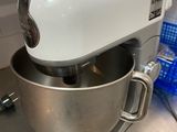 a white mixer sitting on top of a counter