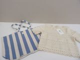 a white sweater and a blue and white striped shirt