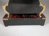 a black and gold clock with a leopard print cover