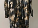 an image of a brown and black tie dyed shirt on a hanger