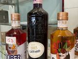 several bottles of alcohol are lined up on a counter