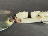 a spoon and a glass on a table next to a toothbrush