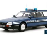 a blue police car that is parked on the side of the road