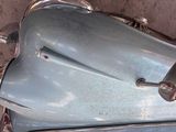 a close up of a blue motorcycle parked on the street