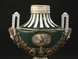a green and white vase with a picture of a man on it