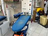 a blue ironing board sitting on a blue table in the middle of a room