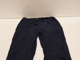 the bottom of a pair of black pants sitting on top of a white table