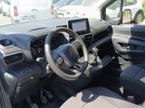 the interior of a small car with a steering wheel and dashboard