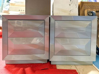 two silver cabinets sitting next to each other on a red carpet