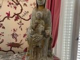 a statue of a woman holding a child on a table