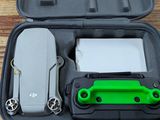 a green and black case with a knife and other items in it