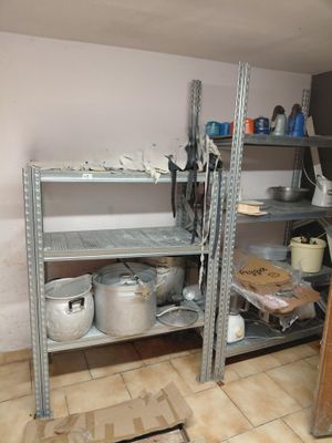 shelves with pots and pans on them in a small room