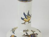 a white vase with blue and yellow designs on it
