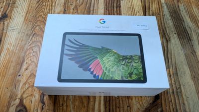 the box is open on a wooden table with a bird on it