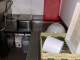 a small kitchen with a sink, stove, and a dishwasher
