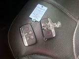 two remotes that are sitting on the seat of a car