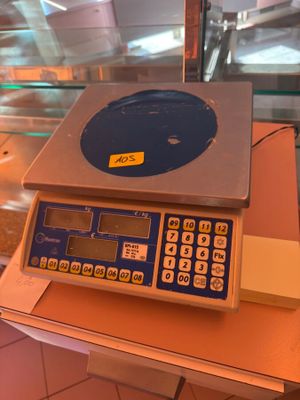 a scale on a table with a glass case in the background