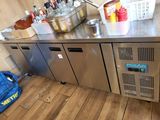 a stainless steel counter with a bunch of bottles on top of it
