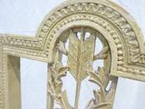 carvings on the back of a wooden chair with a white background