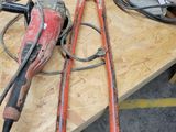 two electric tools on a workbench in a workshop