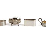 several silver objects including a teapot, a cup, and a saucer