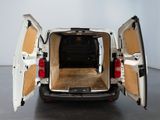 a white van with its doors open in a room