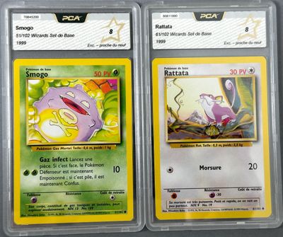 two pokemon cards are on display in a plastic case