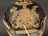 a black and gold helmet with a gold emblem on it