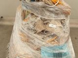 a large pile of items wrapped in plastic on a pallet